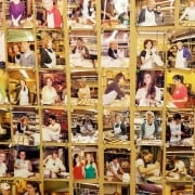 A wall display of numerous photos arranged in rows, highlighting members of the Temple Emanu-El community cooking, baking, and volunteering together—each image reflecting acts of tikkun olam and joyful participation in synagogue social action and outreach programs.