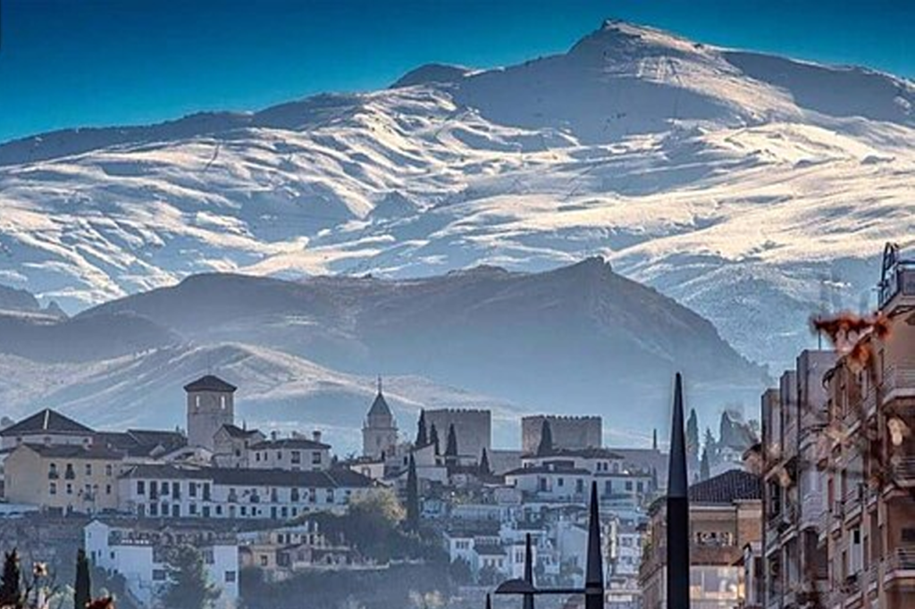 A view of a mountain rising behind the city of Granada, Spain.