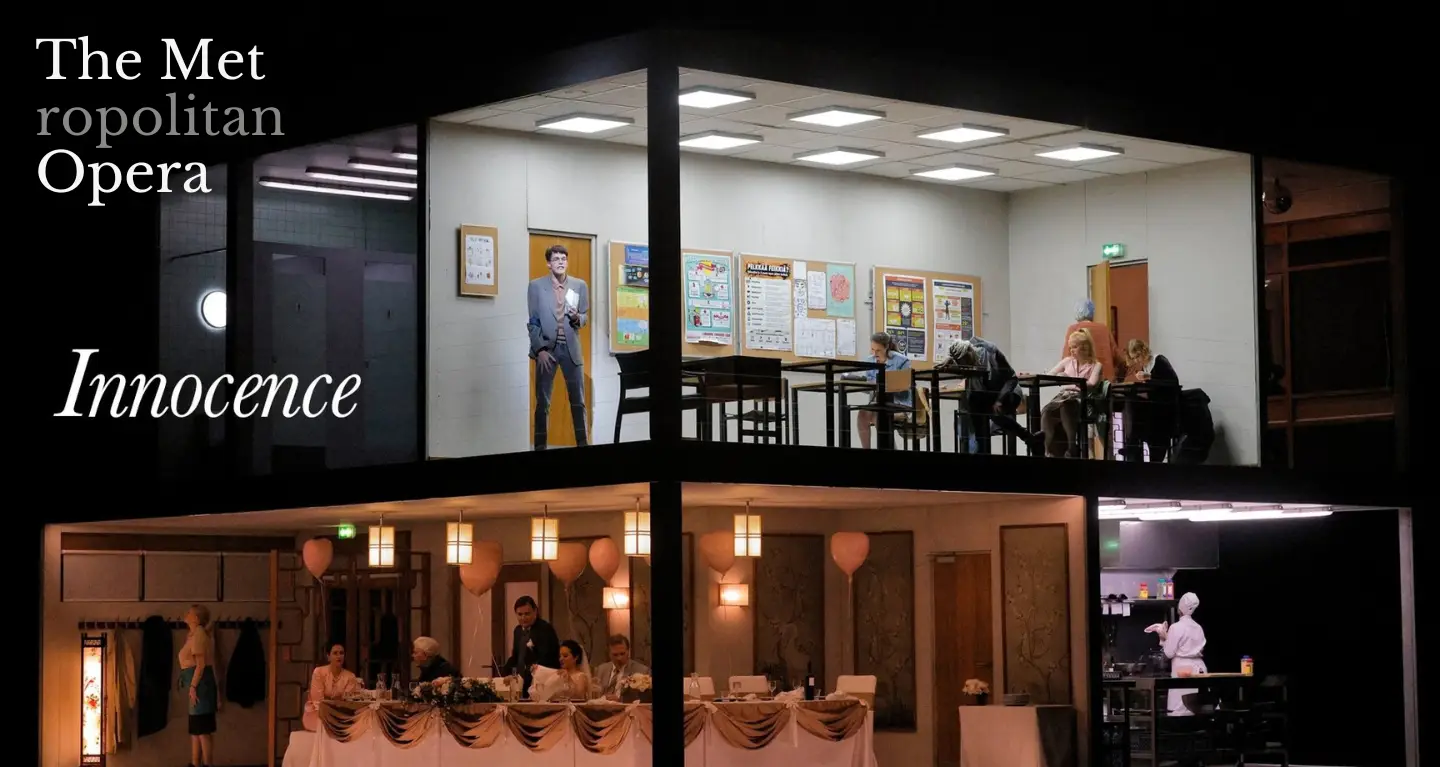 Two-level stage set: people gather at tables below, while above, others are seated in a classroom at Temple Emanu-El.