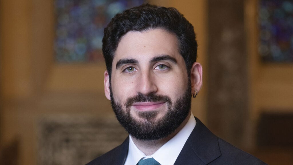 Portrait of a gentleman with a beard, dressed in formal attire, representing a member of the Temple Emanu-El community.