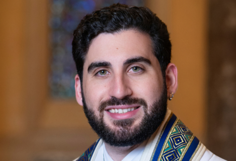 A portrait of a smiling rabbi wearing a tallit at Temple Emanu-El.