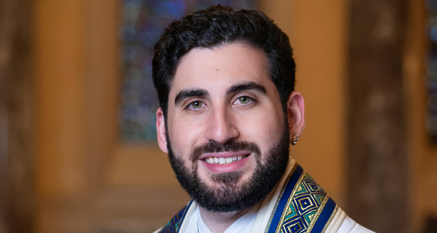 A portrait of a smiling rabbi wearing a tallit at Temple Emanu-El.