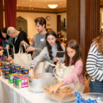 Temple Emanu-El volunteers packing food bags for a tikkun olam community service project.
