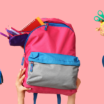 Three colorful backpacks held by hands, filled with school supplies, against a pink background, representing support for students through Temple Emanu-El’s community initiatives.
