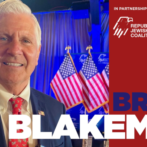 Smiling man in a suit stands in front of U.S. flags, with text on the image stating Bruce Blakeman and Republican Jewish Coalition.