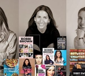 Three women smiling warmly at a book display table, each presenting their published works, with a blend of grayscale and color in the image.