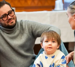A Temple Emanu-El family with a toddler at an event for families with young children.