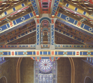 Colorful, ornate wooden ceiling and stained glass windows inside Temple Emanu-El, a major Reform Jewish synagogue in New York City.